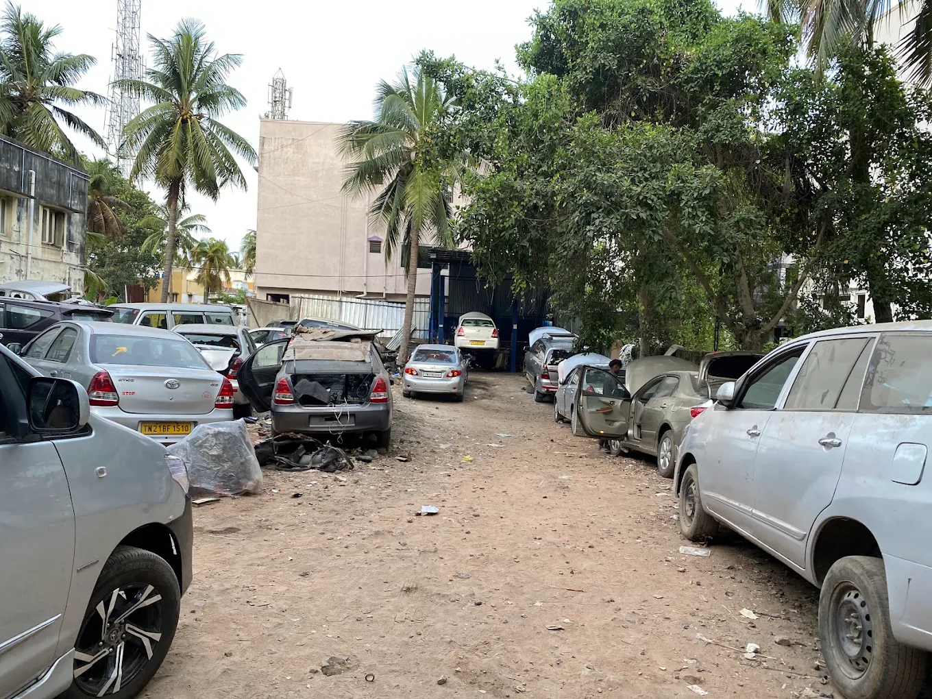 Wide view of the workshop yard with multiple Toyota vehicles under repair