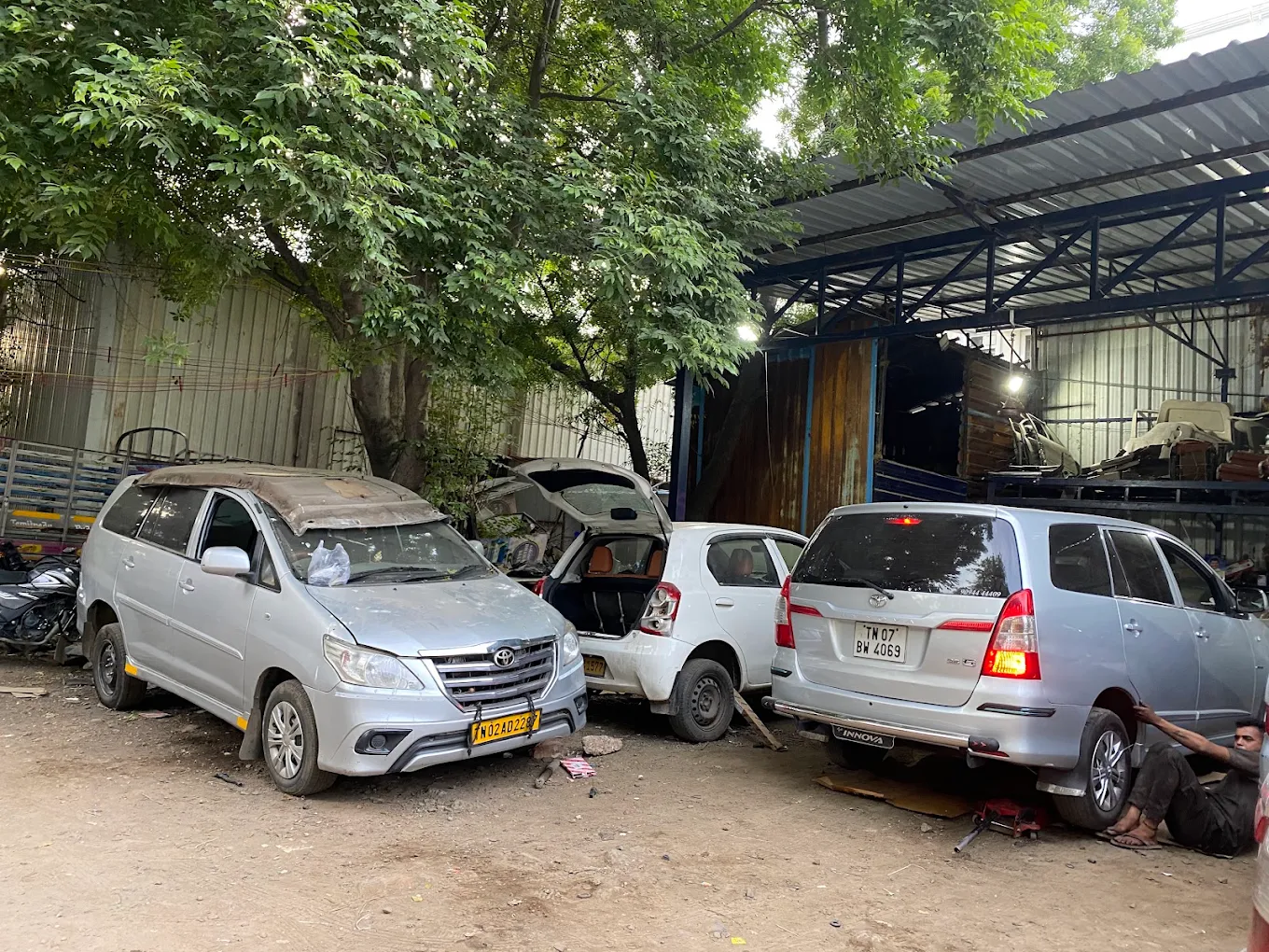 Toyota Innova, Etios and Innova Crysta parked at the workshop during repairs