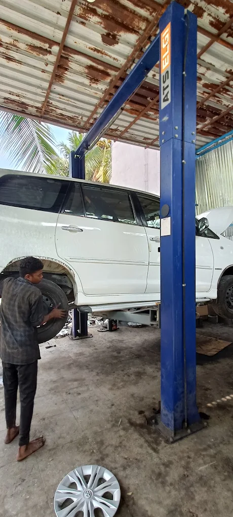 Toyota Fortuner on the hydraulic lift with a technician handling a wheel