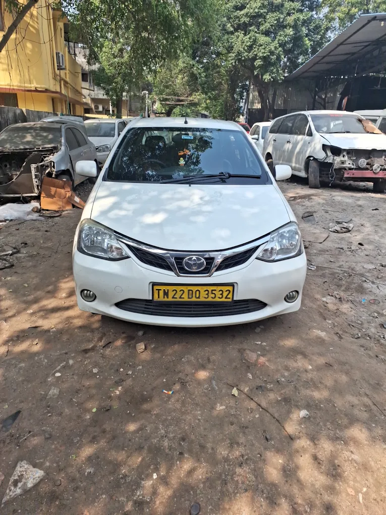 White Toyota Etios parked at the Lins Toyota Services workshop yard